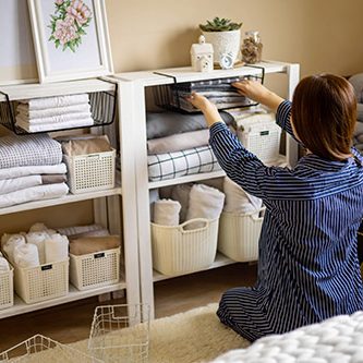 woman organizing home shelving - home organization services